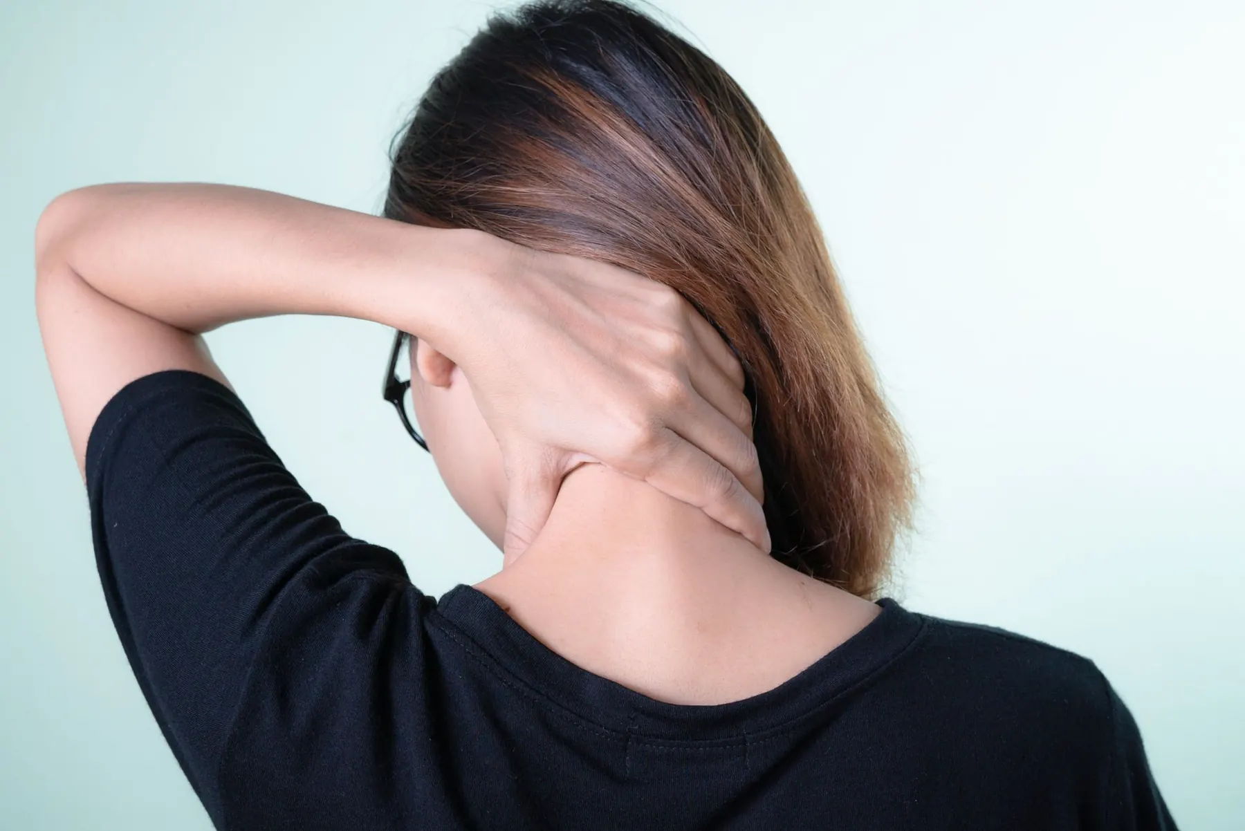 A woman rubbing her neck