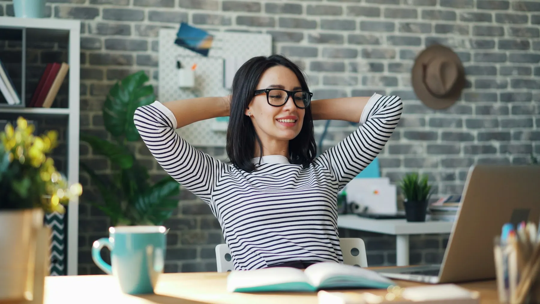 A woman stretching at her desk